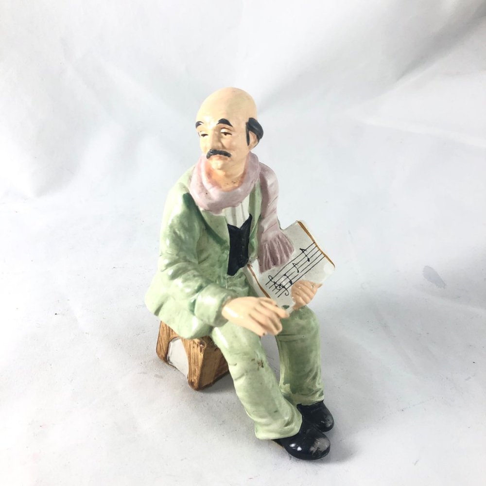Vintage Porcelain Figurine Sitting Man in Green Suit Holding Sheet Music Hand Pa